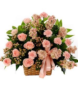 A bouquet of baby pink roses and light pink carnations