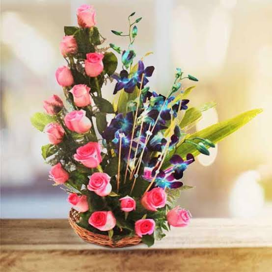 Astounding Basket arrangement with Pink Roses and Blue Orchids