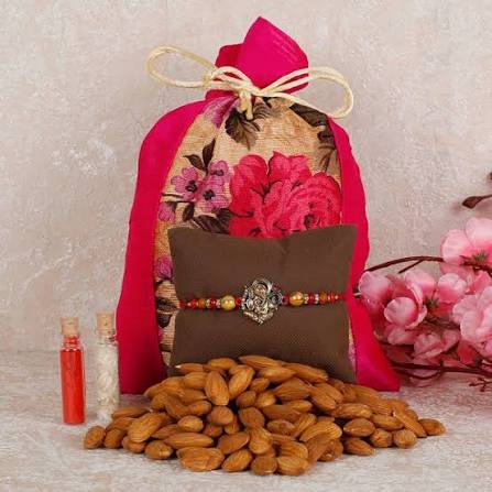 Auspicious Lord Ganesha designer Rakhi with Nutritious Almond Comb