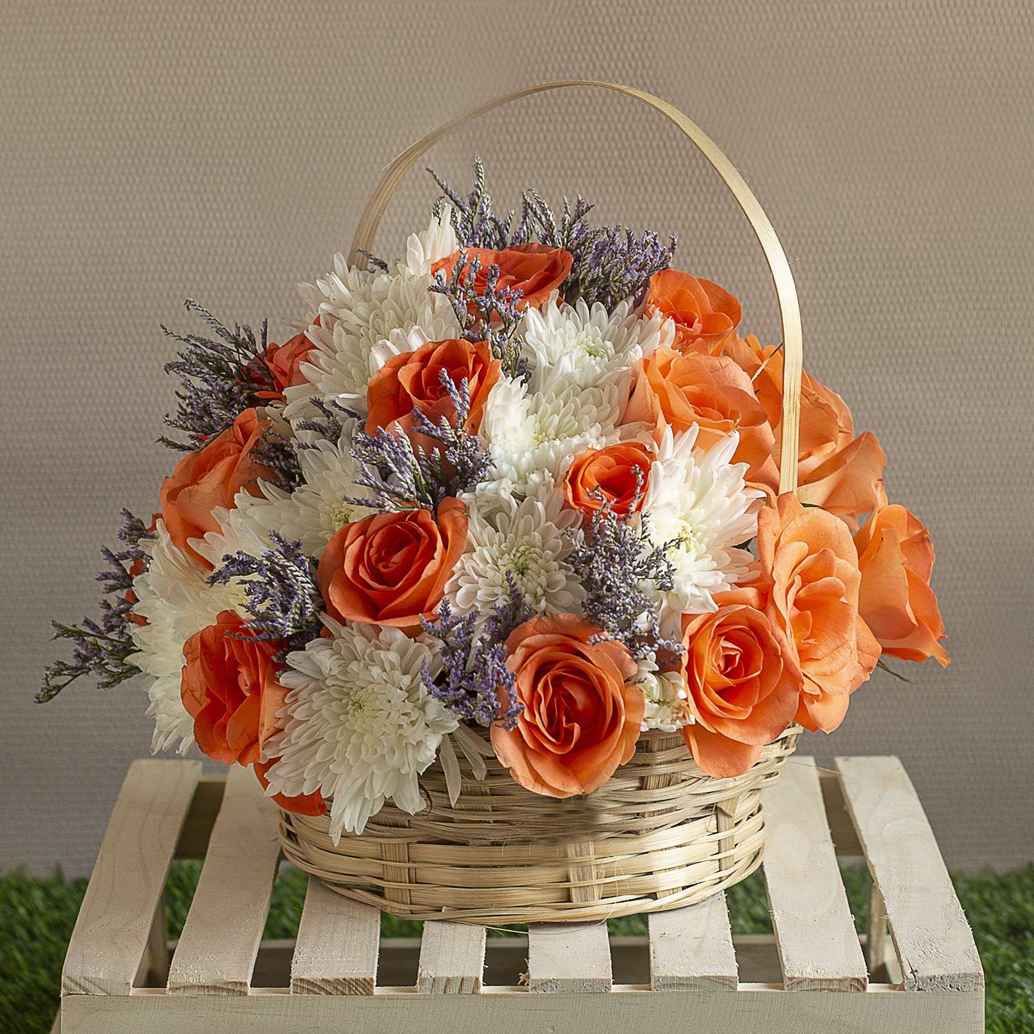 Beautiful orange blooms combined. White chrysanthemum in a basket.