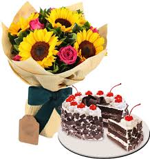 Black forest cake paired with a bouquet of sunflowers and pink roses