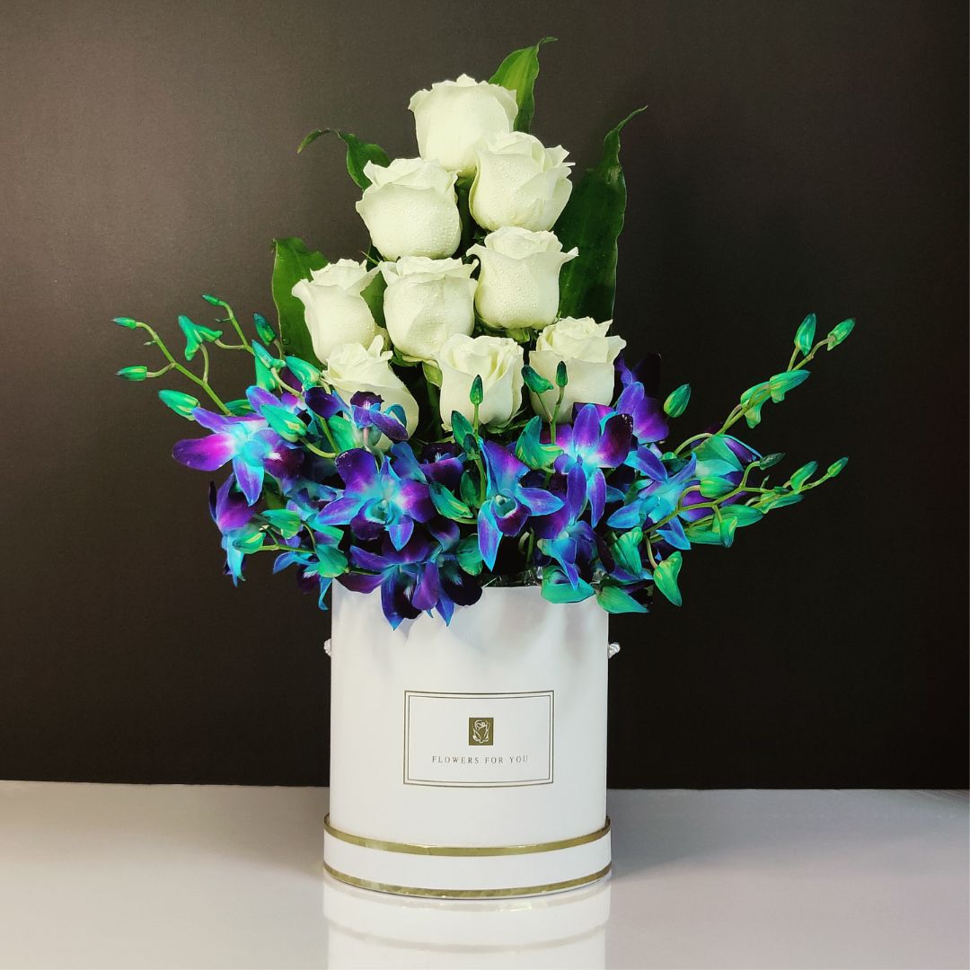 Box arrangement fused with white roses and blue orchids