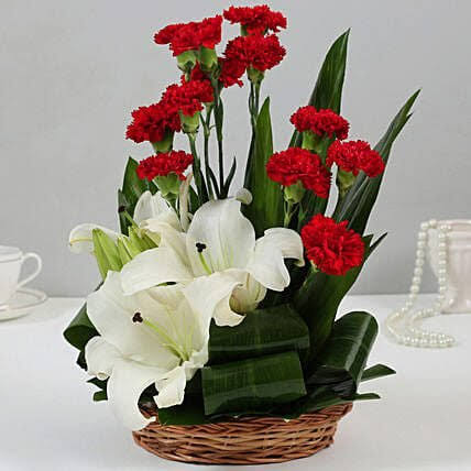 Breathtaking Red Carnations with White lilies fused in a basket