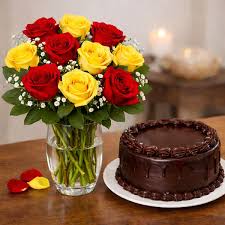 Chocolate truffle cake paired with a gorgeous bouquet of red and yellow roses