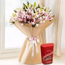 Exotic Pink Lilies Bouquet Paired with Delicious Lindt Chocolate.