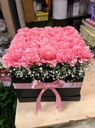 Light Carnations placed in a beautiful Black box