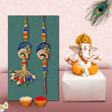 Lord Ganesha Idol Paired with Two Fancy Rakhi