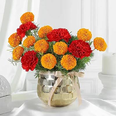Red Carnations with Orange coloured Marigold fused in a Metal Vase