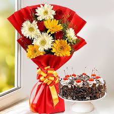 Red, white, and yellow flower bouquet combined with delicious black forest cake.