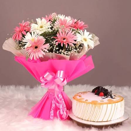 Tasteful Butterscotch Cake with twin shade Gerberas Bouquet
