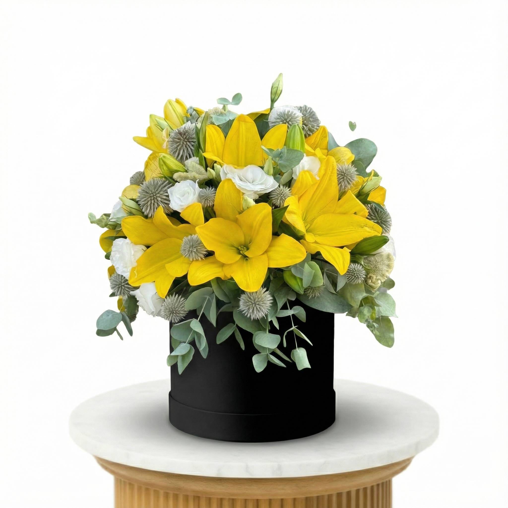 Yellow Lilies and White Roses presented in an elegant box.
